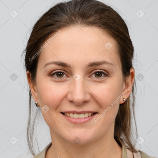 Joyful white young-adult female with medium  brown hair and grey eyes