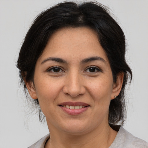 Joyful asian adult female with medium  brown hair and brown eyes