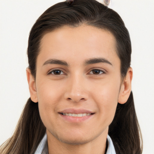 Joyful white young-adult male with long  brown hair and brown eyes