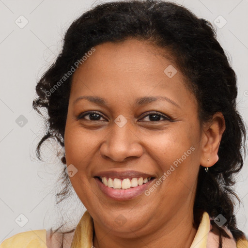 Joyful black adult female with long  brown hair and brown eyes