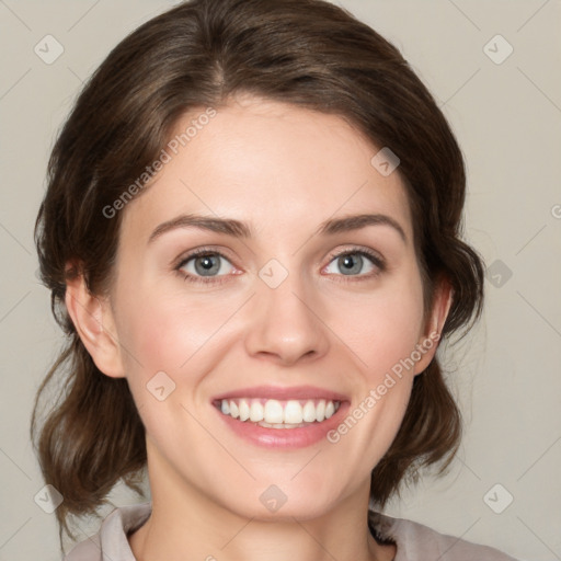 Joyful white young-adult female with medium  brown hair and green eyes