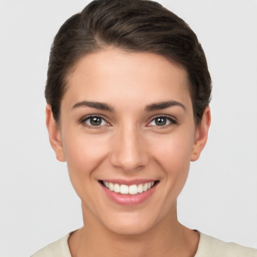 Joyful white young-adult female with short  brown hair and brown eyes