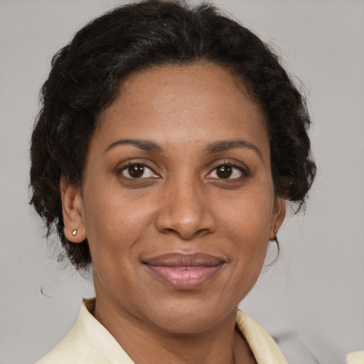 Joyful latino adult female with short  brown hair and brown eyes