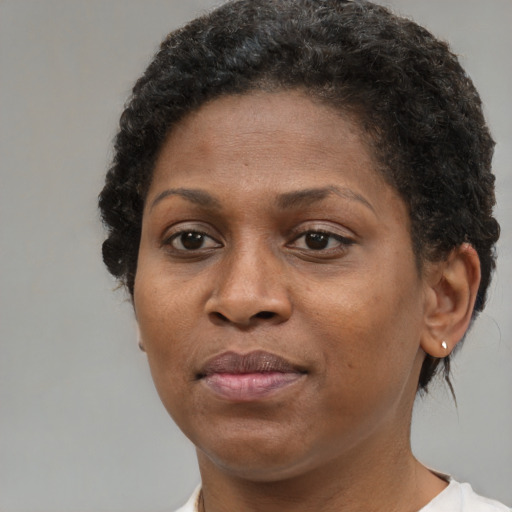 Joyful black adult female with short  brown hair and brown eyes