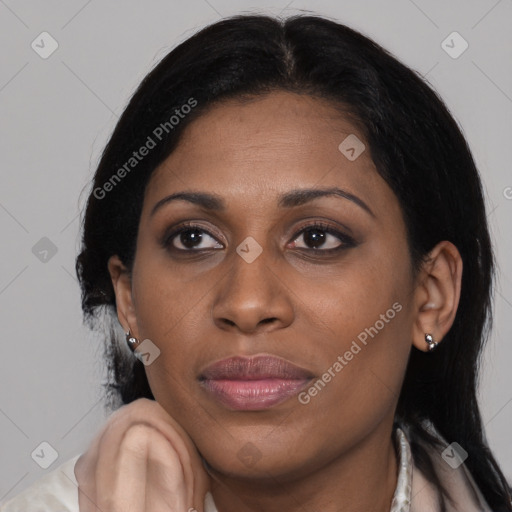 Joyful latino adult female with medium  brown hair and brown eyes