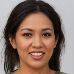 Joyful latino young-adult female with medium  brown hair and brown eyes