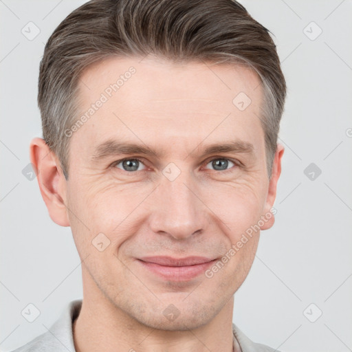 Joyful white adult male with short  brown hair and grey eyes