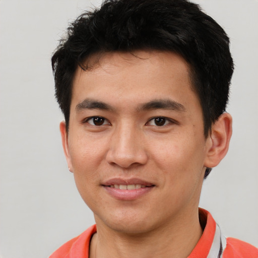 Joyful asian young-adult male with short  black hair and brown eyes