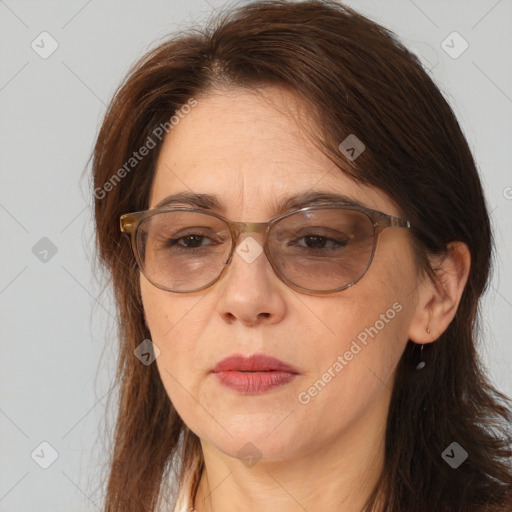 Joyful white adult female with long  brown hair and brown eyes