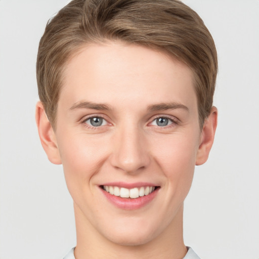 Joyful white young-adult female with short  brown hair and grey eyes