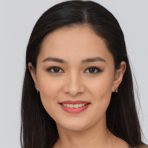 Joyful white young-adult female with long  brown hair and brown eyes