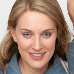 Joyful white young-adult female with medium  brown hair and blue eyes