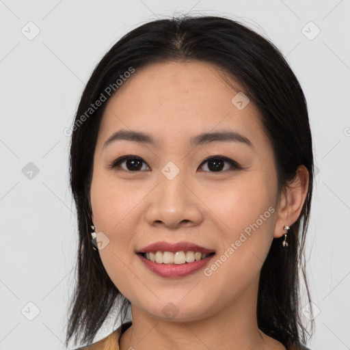 Joyful asian young-adult female with medium  brown hair and brown eyes