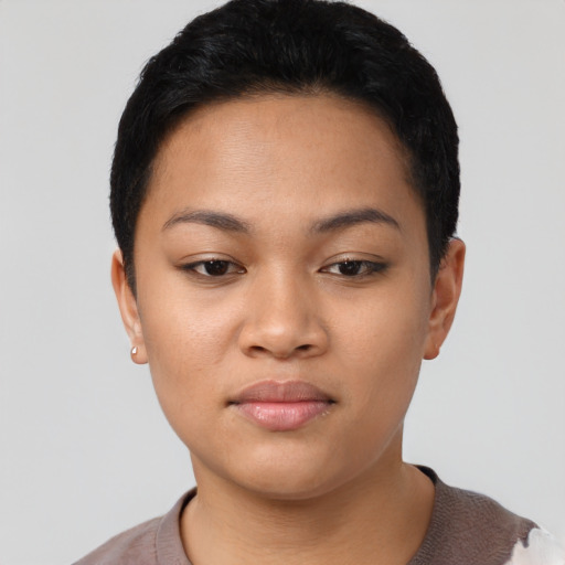 Joyful latino young-adult female with short  black hair and brown eyes