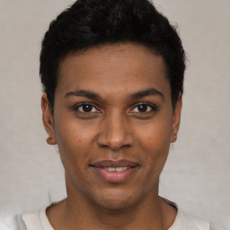 Joyful black young-adult male with short  black hair and brown eyes