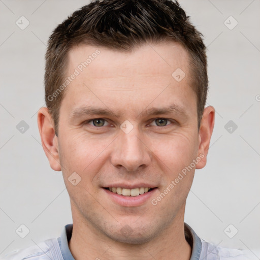 Joyful white adult male with short  brown hair and grey eyes