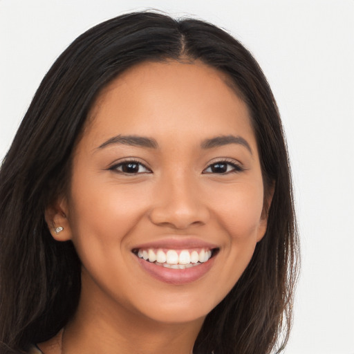 Joyful latino young-adult female with long  brown hair and brown eyes