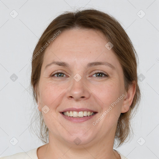 Joyful white adult female with medium  brown hair and grey eyes