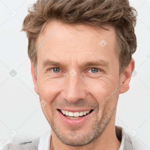 Joyful white adult male with short  brown hair and grey eyes