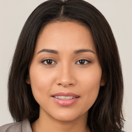 Joyful white young-adult female with long  brown hair and brown eyes