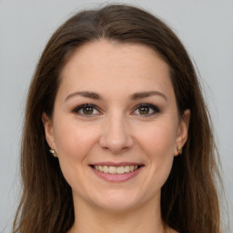 Joyful white young-adult female with long  brown hair and grey eyes