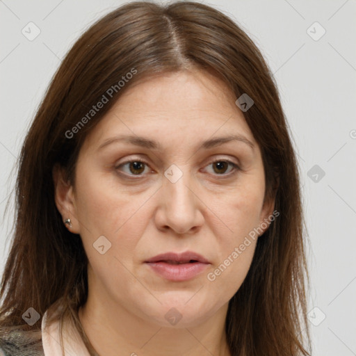 Joyful white adult female with long  brown hair and brown eyes