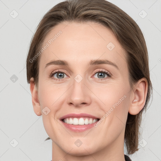 Joyful white young-adult female with medium  brown hair and grey eyes