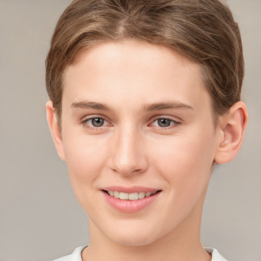 Joyful white young-adult female with short  brown hair and grey eyes