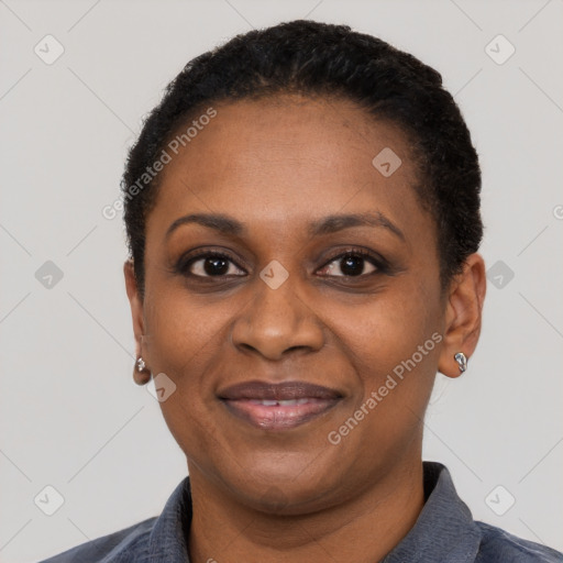 Joyful black adult female with short  black hair and brown eyes