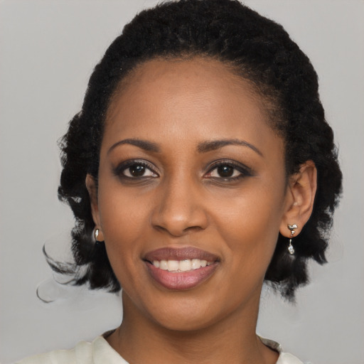 Joyful black young-adult female with medium  black hair and brown eyes