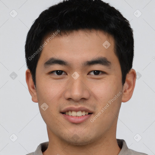 Joyful asian young-adult male with short  black hair and brown eyes