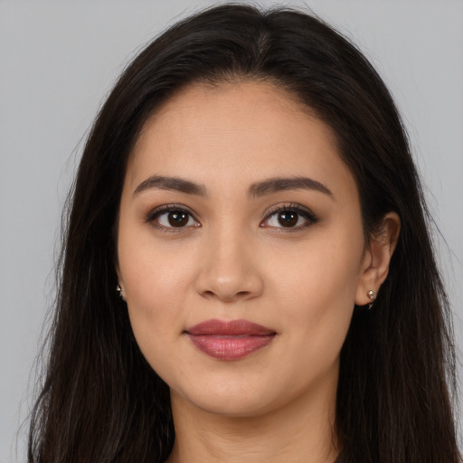 Joyful white young-adult female with long  brown hair and brown eyes