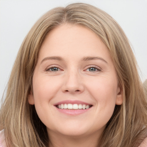 Joyful white young-adult female with long  brown hair and grey eyes