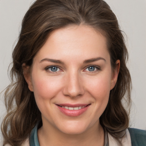 Joyful white young-adult female with medium  brown hair and grey eyes