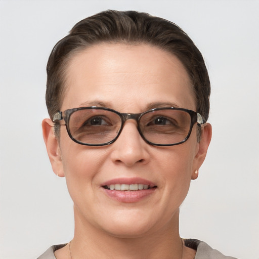 Joyful white adult female with short  brown hair and grey eyes