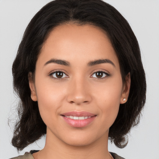 Joyful white young-adult female with medium  brown hair and brown eyes