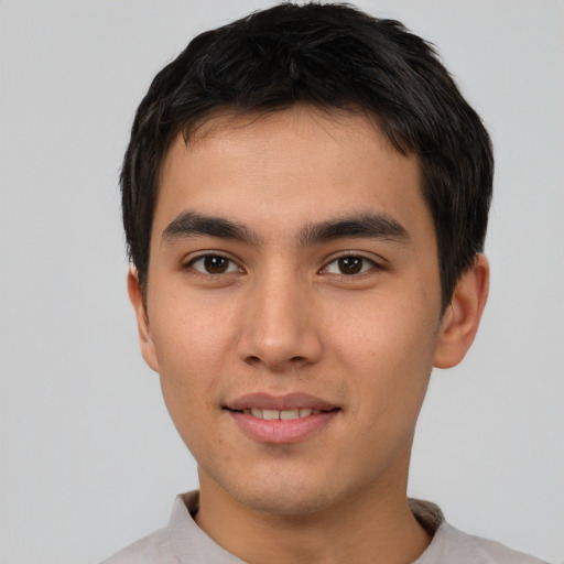 Joyful asian young-adult male with short  brown hair and brown eyes