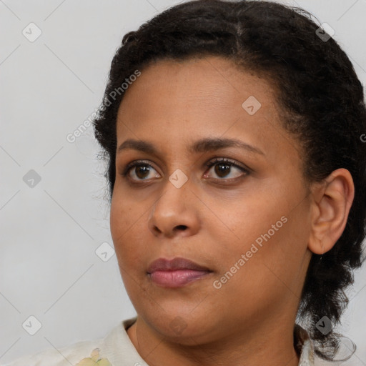 Neutral black young-adult female with medium  brown hair and brown eyes