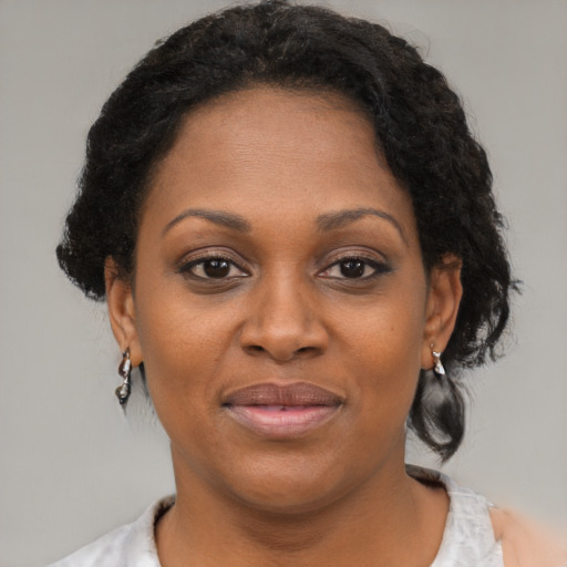 Joyful black adult female with short  brown hair and brown eyes