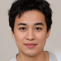 Joyful asian young-adult male with short  brown hair and brown eyes