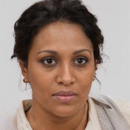 Joyful black adult female with short  brown hair and brown eyes