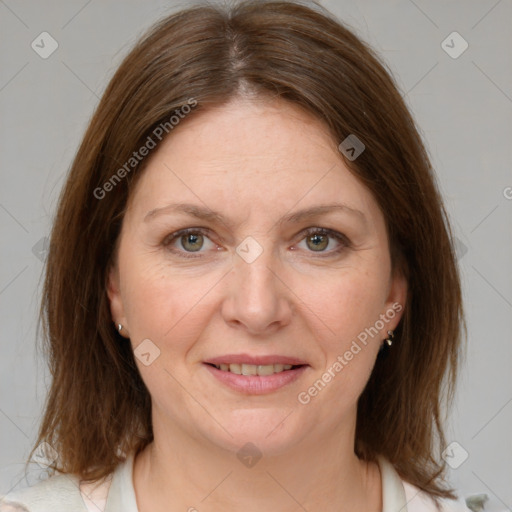 Joyful white adult female with medium  brown hair and grey eyes