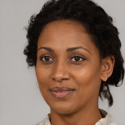 Joyful black adult female with medium  brown hair and brown eyes