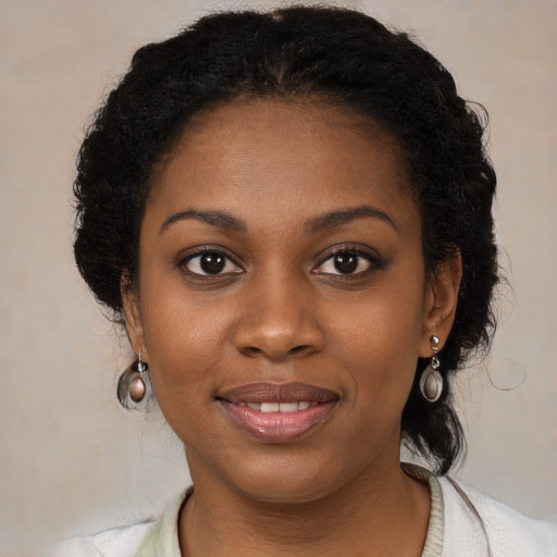 Joyful black young-adult female with medium  black hair and brown eyes