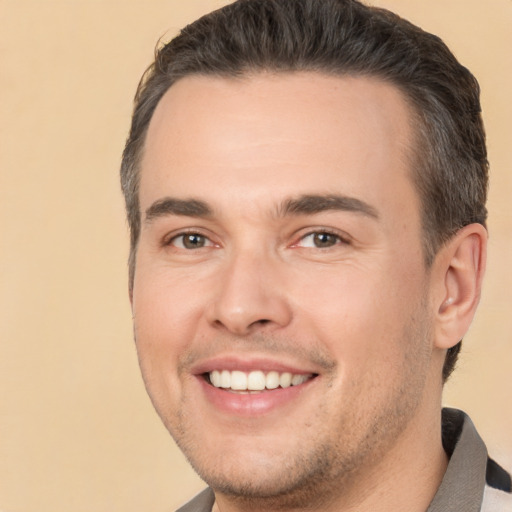 Joyful white young-adult male with short  brown hair and brown eyes