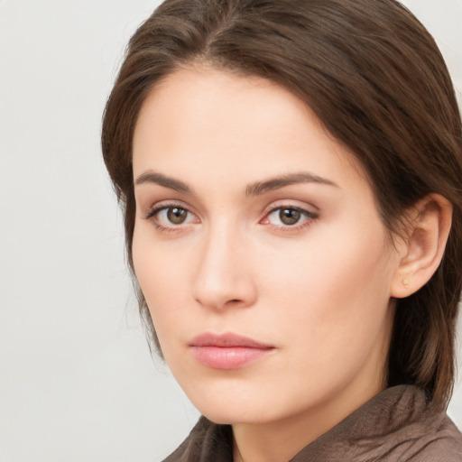 Neutral white young-adult female with long  brown hair and brown eyes