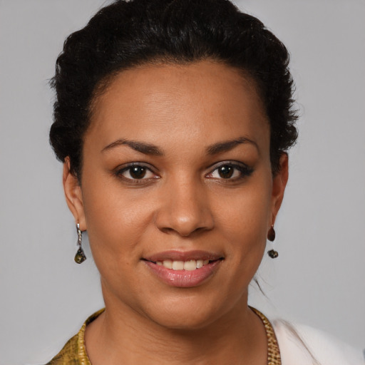 Joyful latino young-adult female with short  brown hair and brown eyes