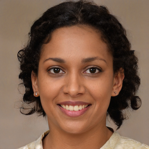 Joyful black young-adult female with medium  brown hair and brown eyes