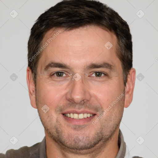 Joyful white adult male with short  brown hair and brown eyes