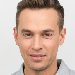 Joyful white adult male with short  brown hair and brown eyes